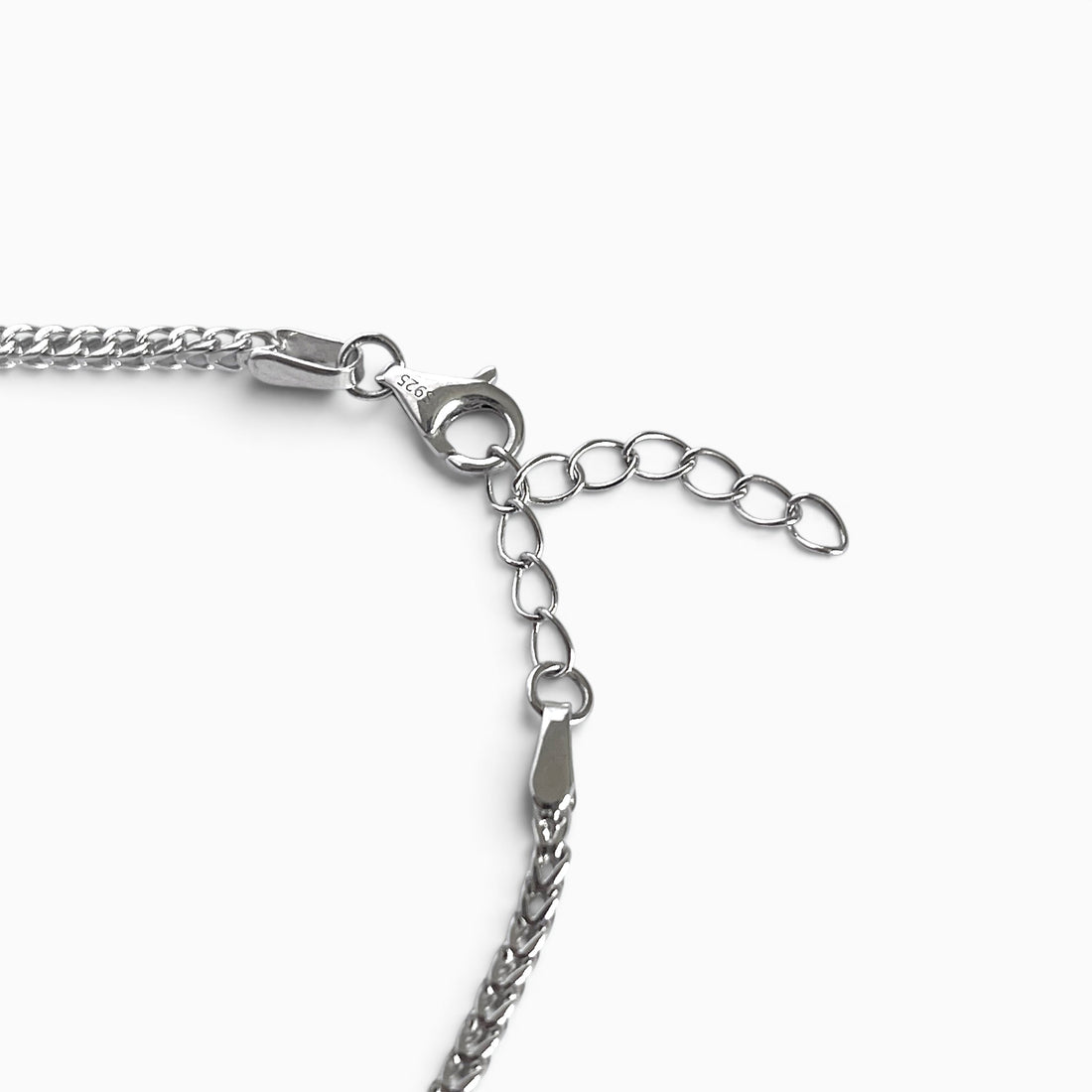 Bracelet chaîne en argent rhodié maille franco posé à plat, avec son fermoir mousqueton